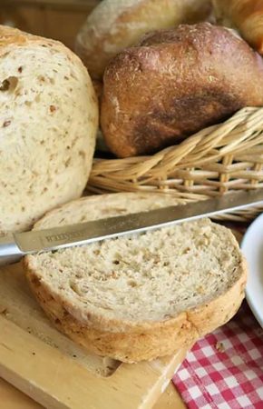Fresh-bread-sliced-with-knife
